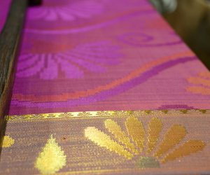 Saree being rolled out on handloom