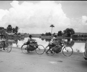 Group of coal carriers carrying coal along a pond