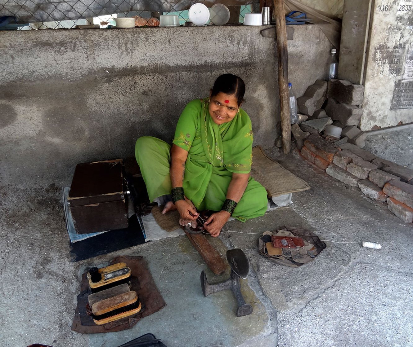 01-Bhamabai_DSC01558-NW-Fixing Straps and Mending Soles.jpg