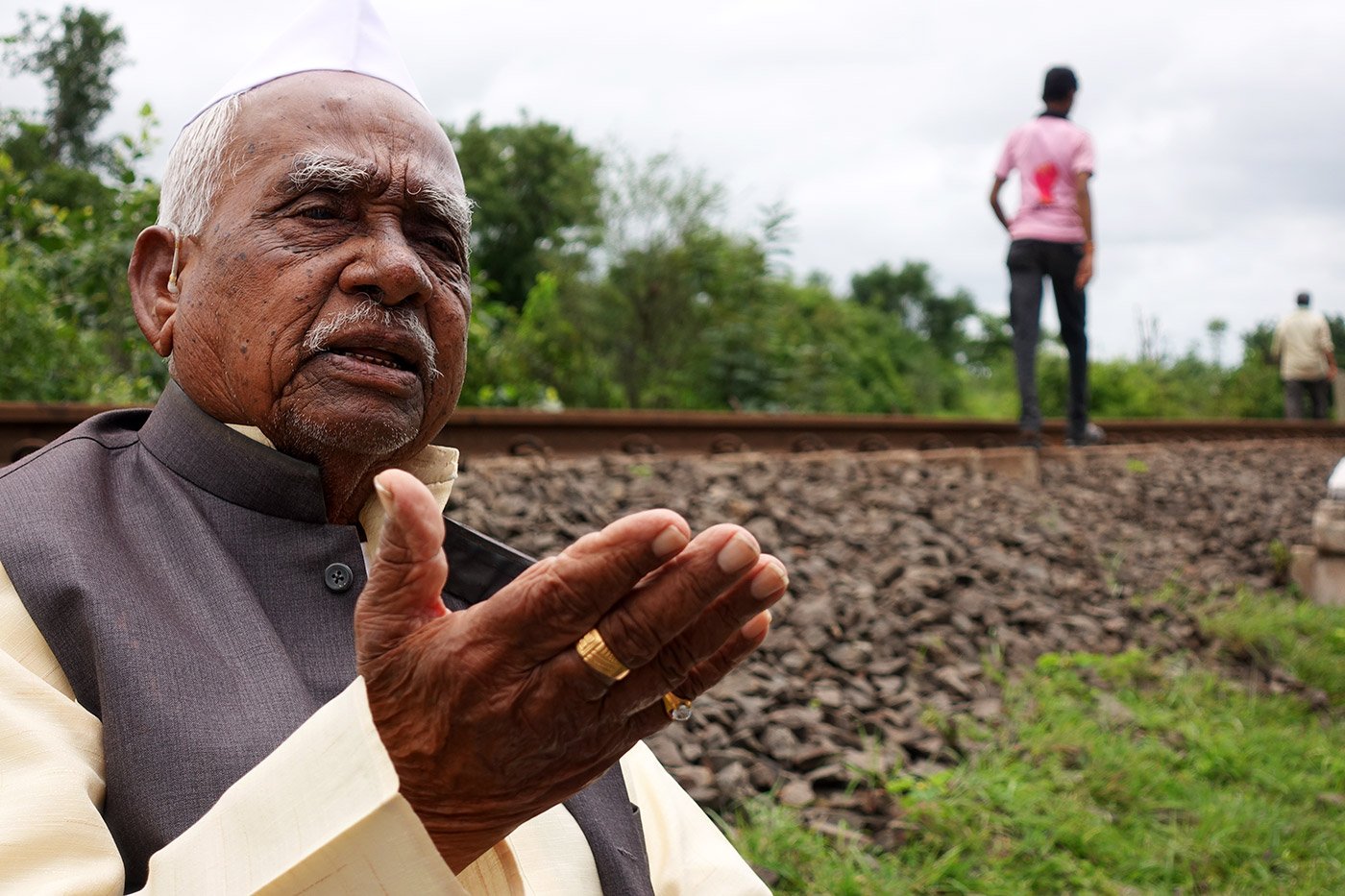 Close up of Ramchandra Sripati Lad with two men in the background