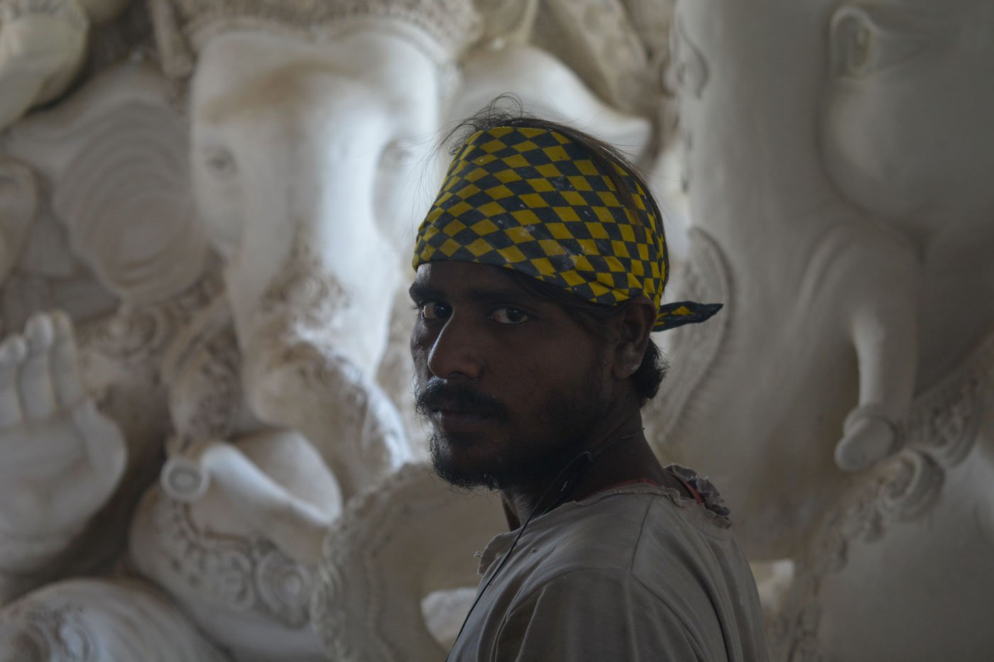 Babban standing in front of idols