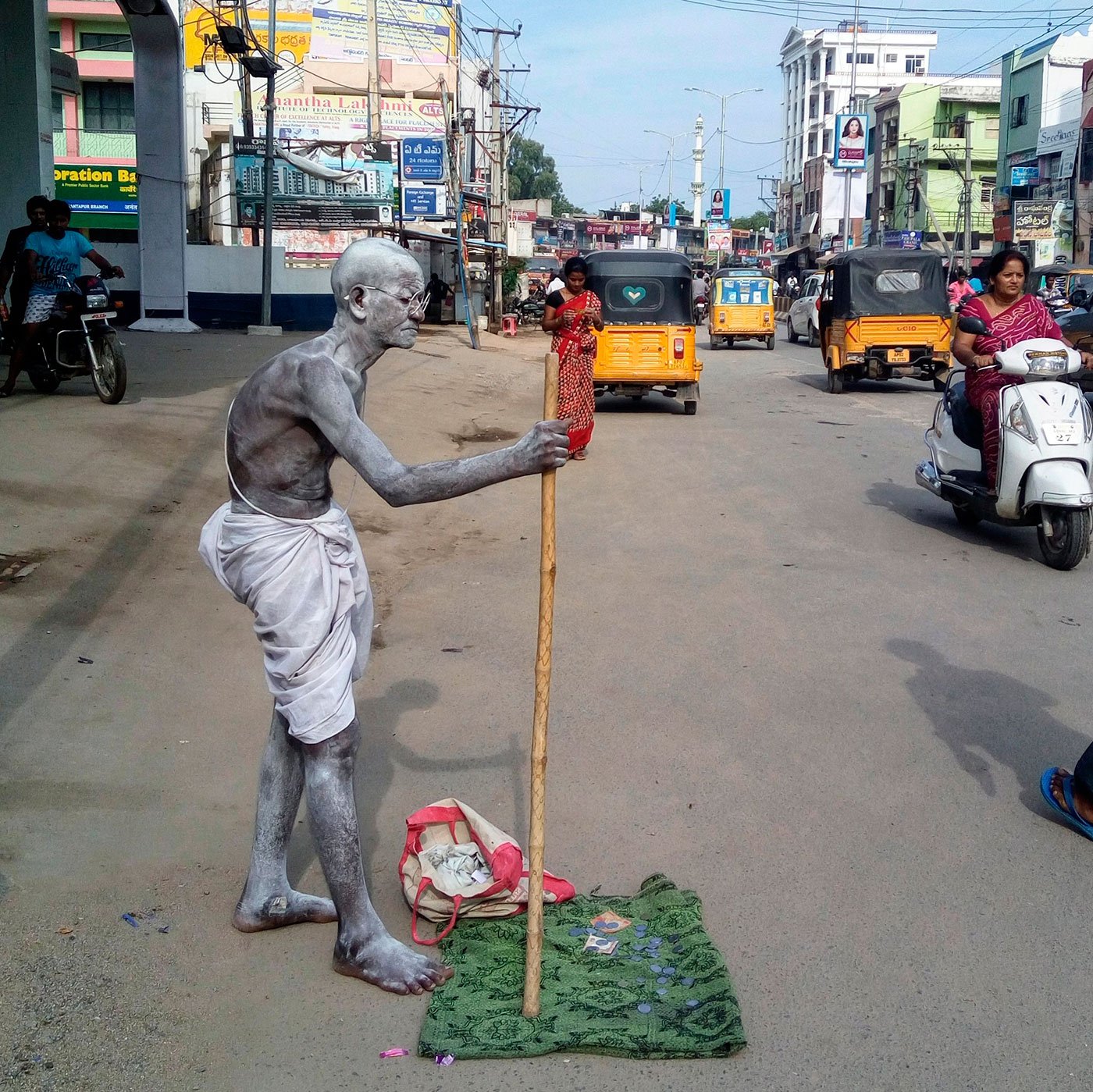 Gangappa standing beside road a attire of Mahatma Gandhi