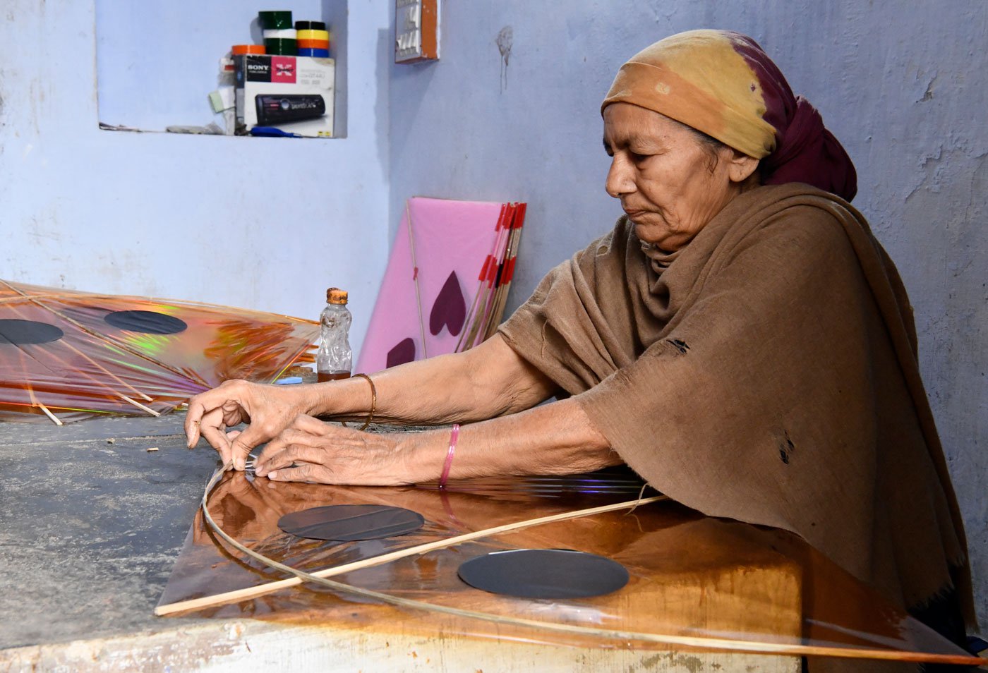 The harsh lives of the women kite makers of Khambhat and Ahmedabad stand out in stark contrast against the brilliantly coloured skies they light up with their labour