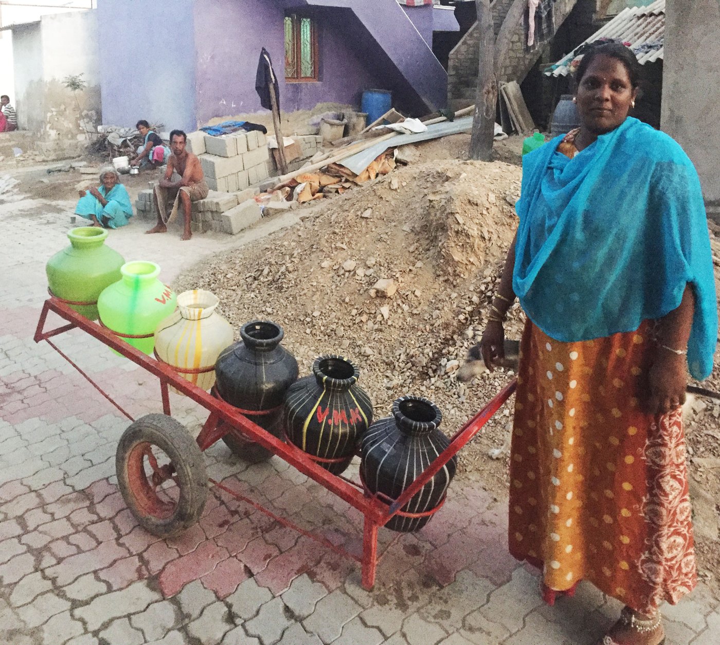 Subbulakshmi with trolley carrying water