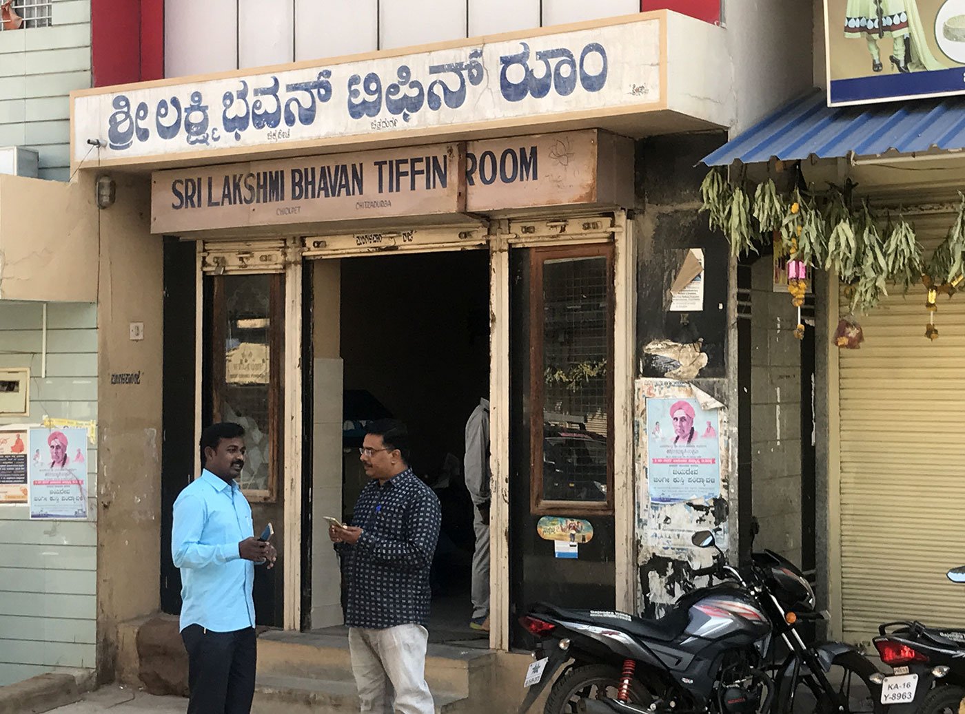 Two men standing outside a restaurant