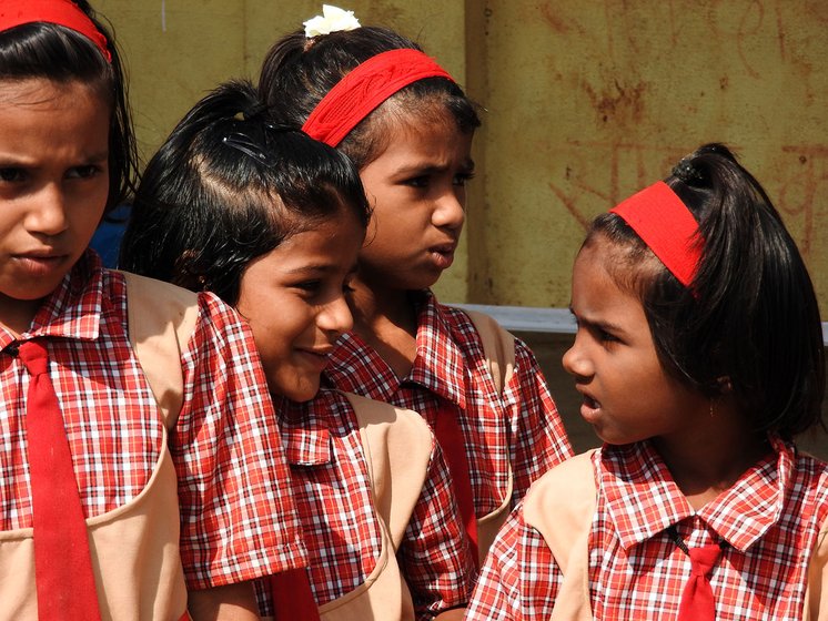 Girls singing outside a school