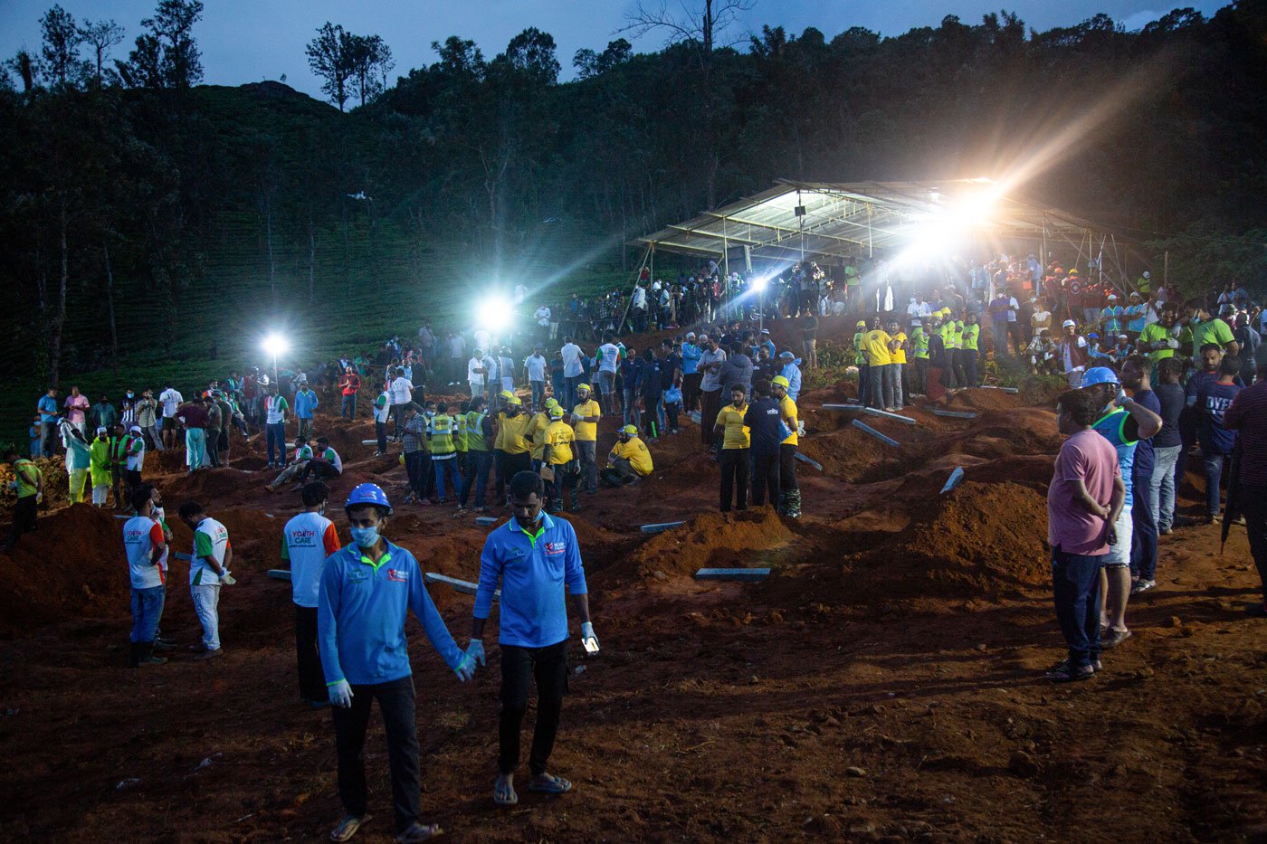 Working through the night, volunteers await the arrival of bodies