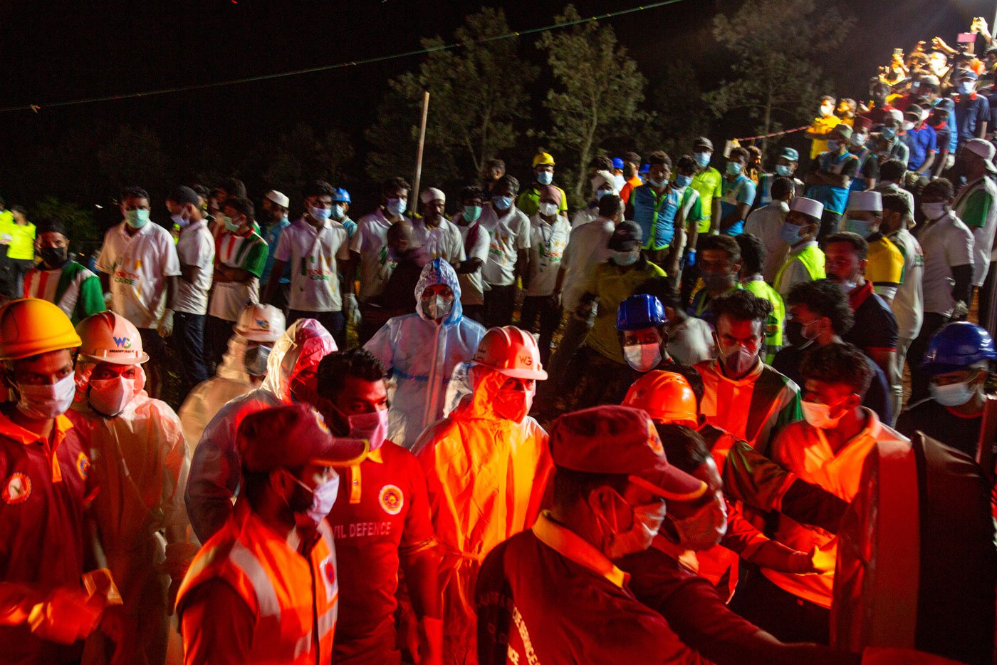 Volunteers equipped with emergency kits prepare to collect the bodies from the ambulances