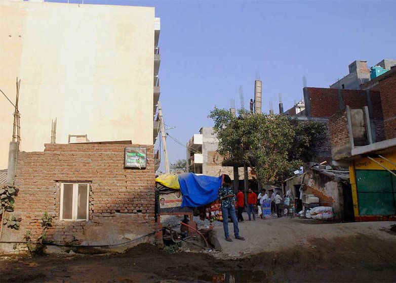 Putul Daloi lives in Bengali Mohalla (left) in New Delhi , not far from the mall where her husband worked