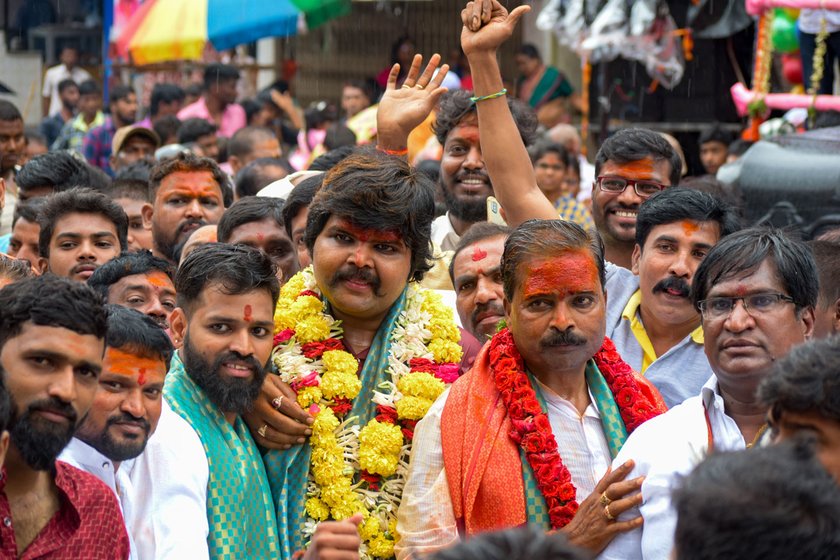 Ashwin and his father Posani Babu coming out of the temple