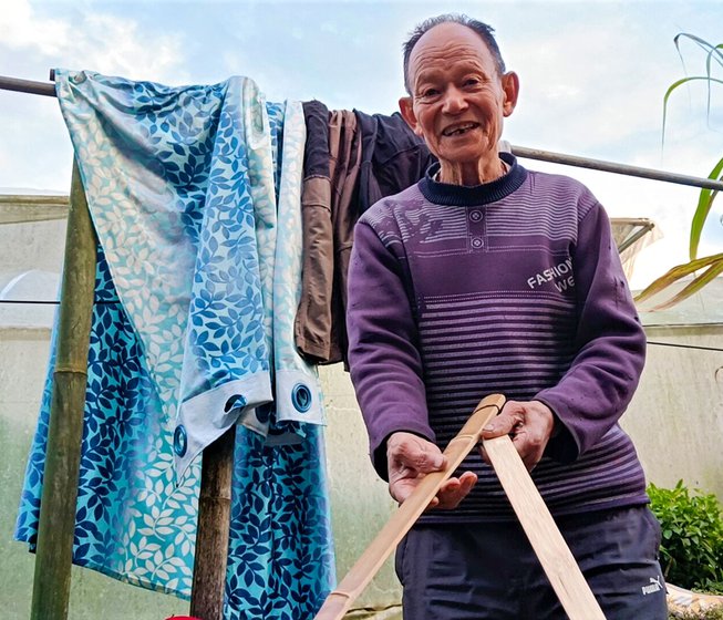 Left: Tshering Dorjee with pieces of the stick that are joined to make the traditional tabjoo bow. Right: His elder son, Sangay Tshering (right), shows a finished tabjoo