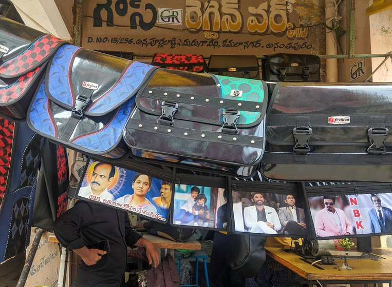 Outside a rexine shop, motorbike saddlebags with pictures of film stars and politicians