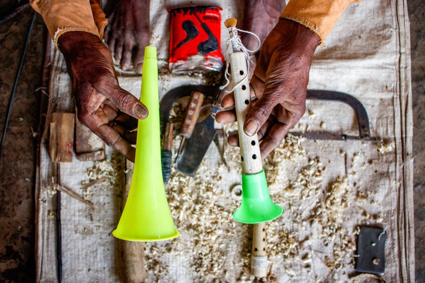 Narayan shows the plastic trumpet (left), which he now uses as a replacement for the brass bell (right) fitted at the farther end of the shehnai