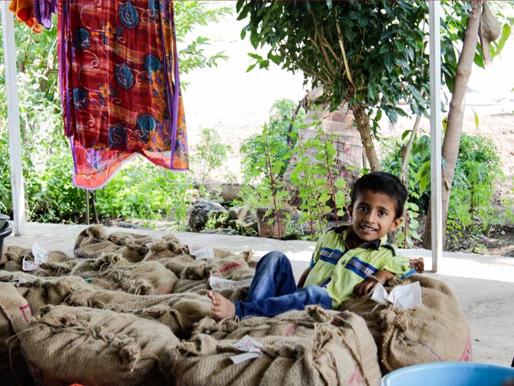 Grandson of Sonubai Mote of Savindane village lying on potato sacks