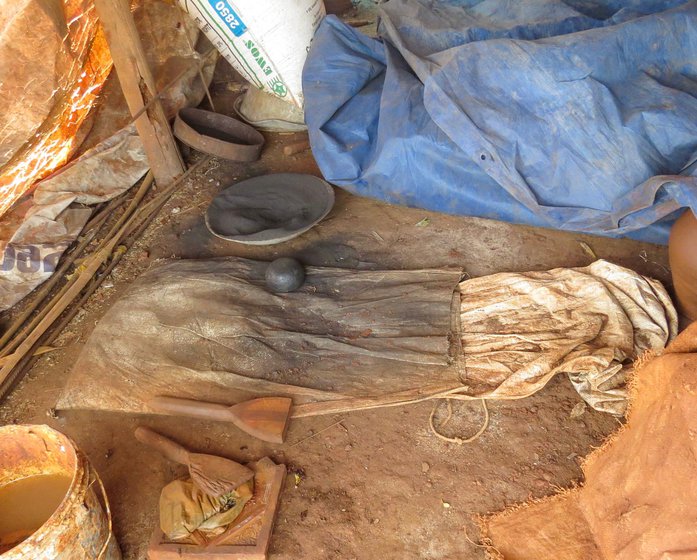 The bowl of ash (right) helps ensure his hand doesn't stick to the wet pot