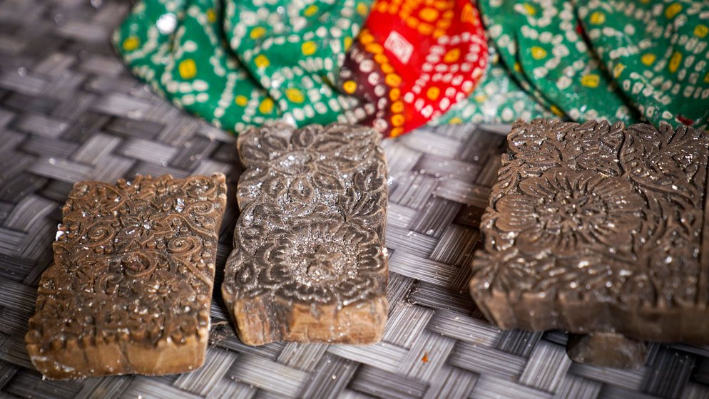 Mohammad Asghar (left) is a chhapa craftsman during the wedding season. The rest of the year, when demand shrinks, he works at construction sites. He uses wooden moulds (right) to make attractive designs on clothes that are worn on festive occasions, mostly weddings of Muslims in Bihar's Magadh region