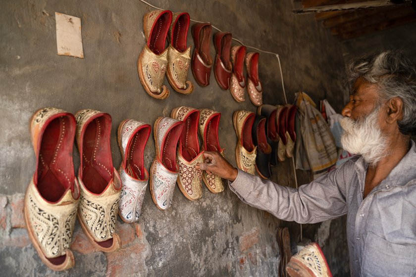 Right: Inside the workshop, parts of the walls are covered with juttis he has made.