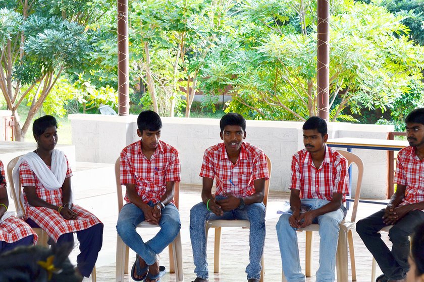 Boys sitting and discussing