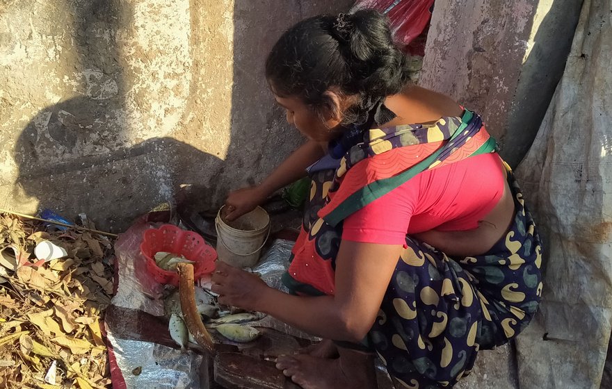 Left: Kasarapu Dhanaraju sold the fish secretly, on a 'stall' on his old rusted cycle. Right: Pappu Devi, who cleans and cuts the fish, says, 'I think I will survive [this period]'

