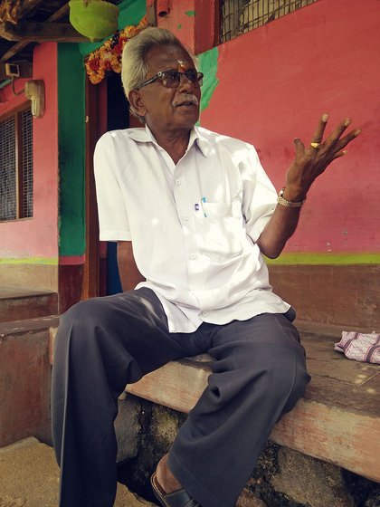 A farmer sitting in front of a home