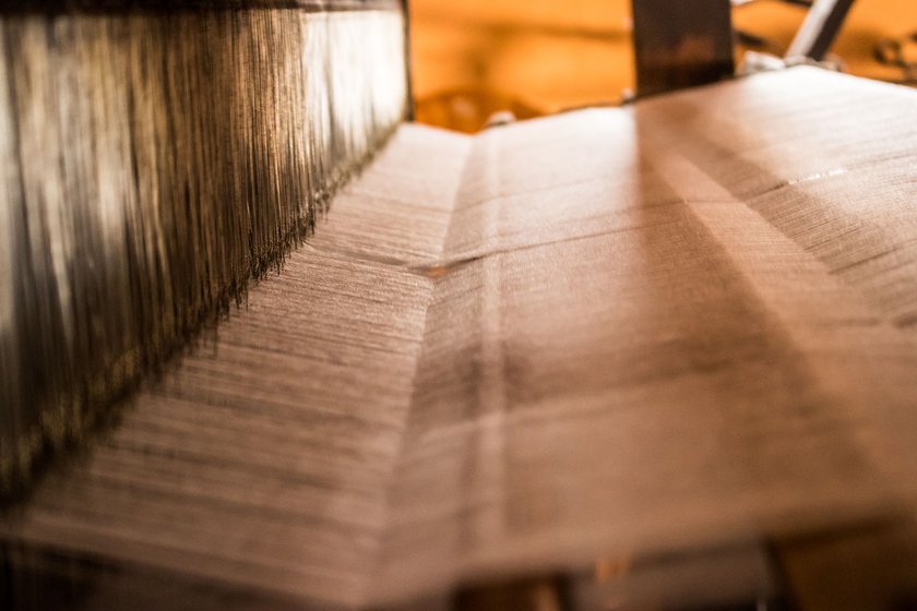 The warp passes through 3,500 wire heddles of the handloom. It helps in separating the warp threads and helps the steady passage of the weft thread