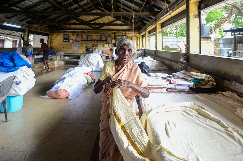 Right: Sarojini i roning out wrinkles; she has been working here since she was 15