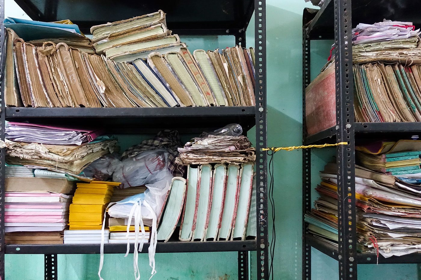 Documents and books stacked up on shelves