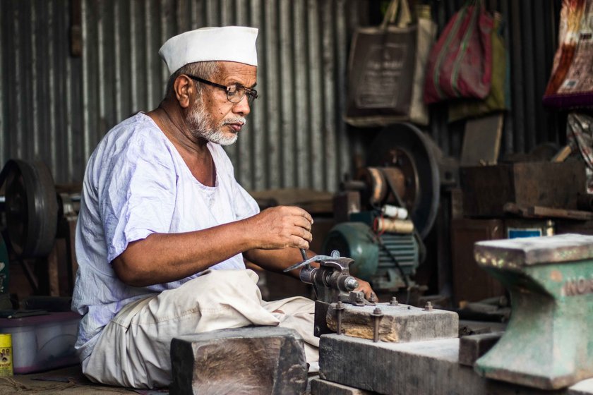 Dilawar (left) meticulously files off swarfs once the nut cutter’s basic structure is ready; Salim hammers an iron rod to make the lower handle of an adkitta

