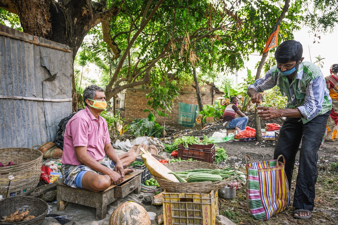 Ram Dutta, a 56-year-old vegetable seller, buying lemon tea from Santi Halder. His income has dropped to half his daily earnings of Rs. 300. He says, “I didn't have a lot of sales before, now it's even worse.” Santi Halder, 48, has been selling jhal muri (a popular street food in West Bengal) for 20 years, but with lockdown restrictions on cooked food, is selling tea. His income too has dropped from Rs. 250-300 to Rs. 100-120 a day.