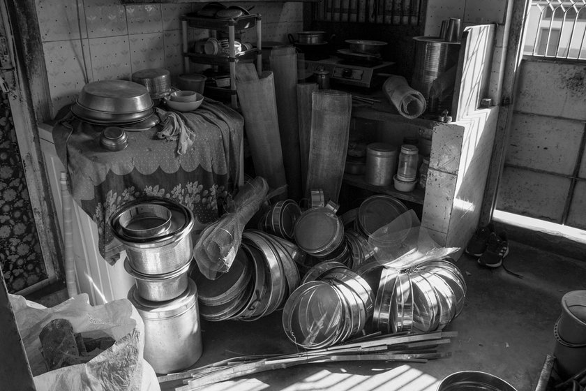 Left: Sieves and mesh to be placed in the sieves are all over his kitchen floor.