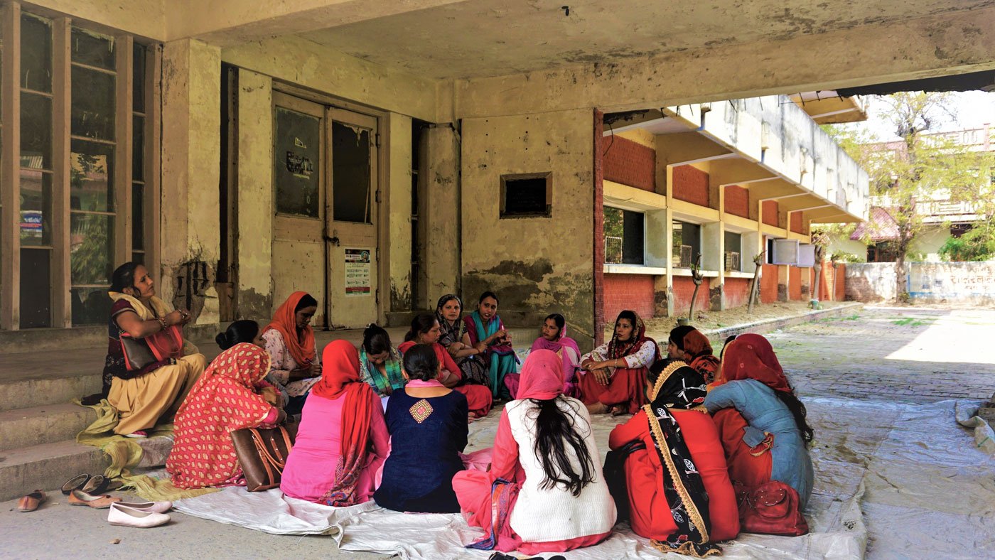 'We don’t even have time to sit on a hartal,' says Sunita Rani; at meetings, she notes down (right) the problems faced by co-workers