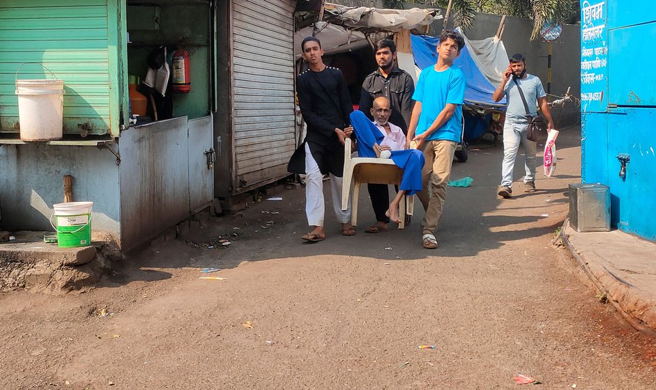 Carrying the chair are his eldest son Abdul Ayaan, a neighbour's son and a nephew.