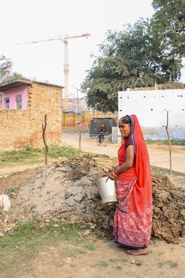 Gyanmati (left) in the courtyard of her house which lies in the vicinity of the Ram temple, and with her family (right). Son Rajan (in a blue t-shirt) is sitting on a chair