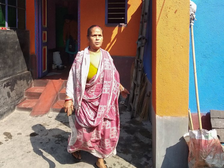 Left: Carrying a sickle in her hand, Minoti Mal leads the way to their six katha danga-zomin (cultivable piece of land) to show a bamboo grove.