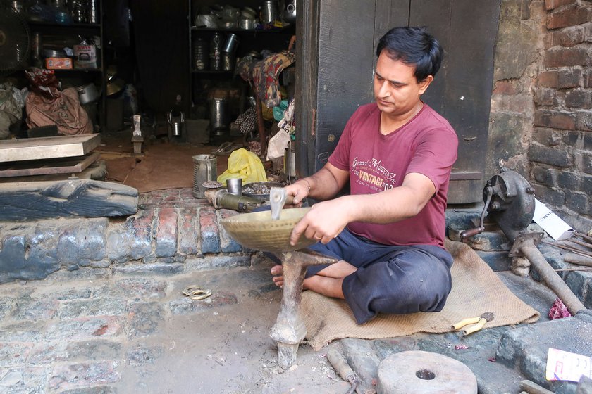 Sunil Kumar removes the handles of a kadhai before cleaning it. The utensil is going to be passed on from a mother to her daughter at her wedding.