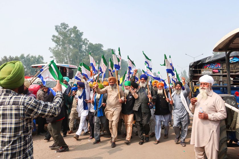 Left: Farmers moving towards the make-shift stage set up on a tractor at Shambhu .