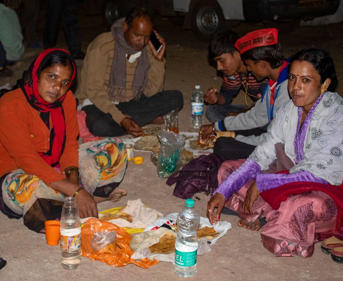 Left: Many had packed a simple meal from home for dinner. Right: At night, the protestors lit up the slogan 'Save Farmers, Save Nation'