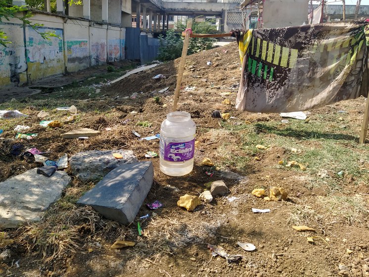 Left: Children taking a bath near the road settlements. Right: An enclosure created for men to bath