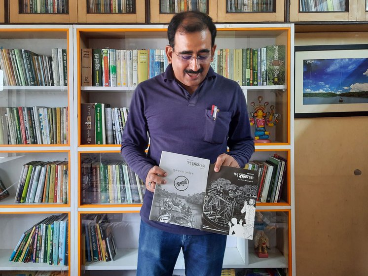 Lahiri has been collecting news (left) about the Sundarbans for many years. 'When it isn’t raining or flooded, the Sundarbans is rarely in the news,' he says. He holds up issues of Sudhu Sundarban Charcha (right), a magazine he founded in 2010 to counter this and provide local Indian and Bangladeshi perspectives on the region