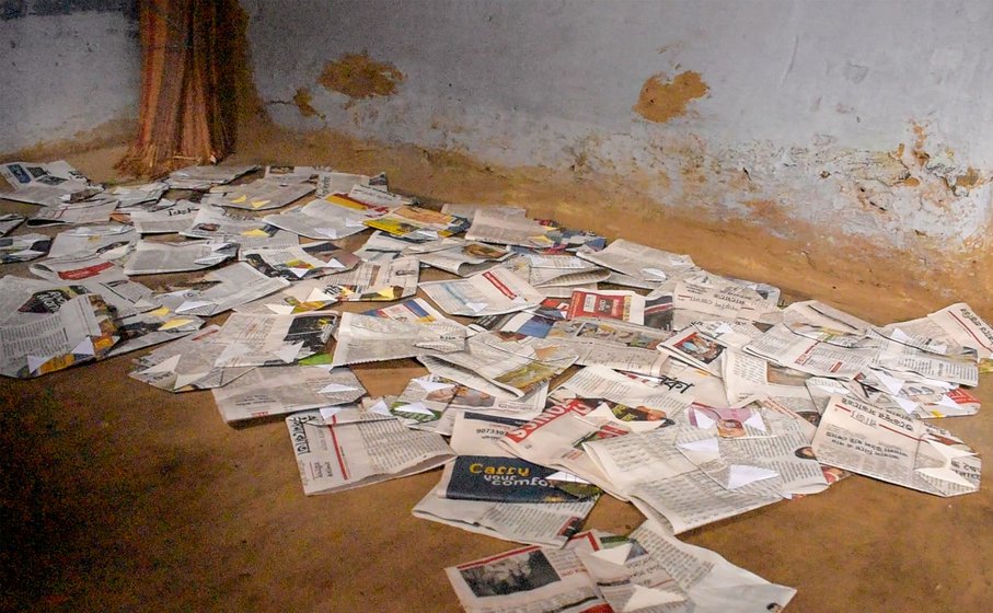 Right: Paper bags smeared with glue are laid out to dry in the verandah and courtyard