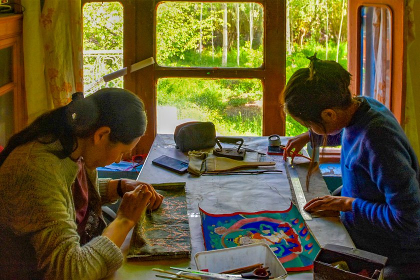 Right: Stanzin Ladol and Rinchen Dolma restoring two Thangkas.