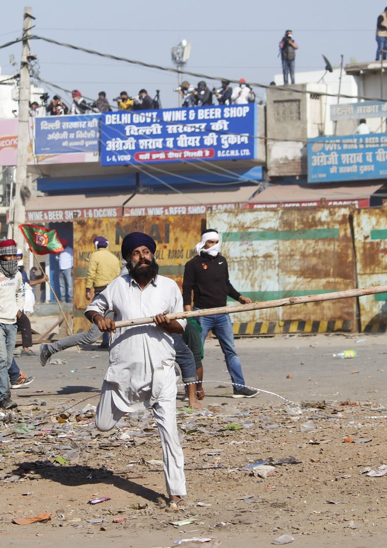 November 27: 'When protestors block a road or damage it, they are branded as criminals. What if governments do the same? Are they not what they call us?' asks 70-year-old Harinder Singh Lakha (not in these photos) from Punjab's Mehna village