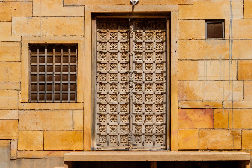 Anoparam also handmakes kamaicha and sarangi (left), popular musical instruments of Jaisalmer. He also makes doors on which he carves flowers (right). Anoparam takes almost a week to make one such door