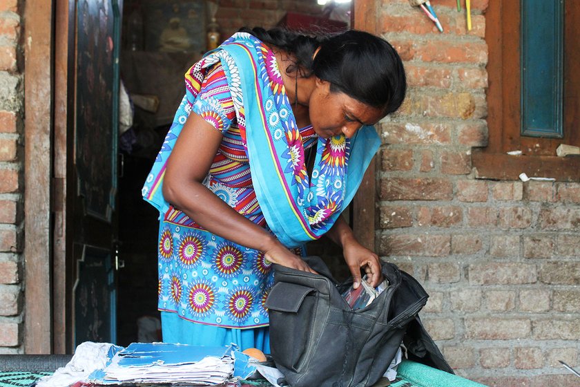 Mangola Singh sifts through her legal papers in her home in the village of Nandpur (Udham Singh Nagar), Uttarakhand