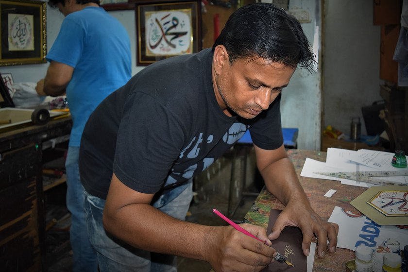 Muhammad Faheem with his brother Zainul Abedin  in their shop in Jamal market