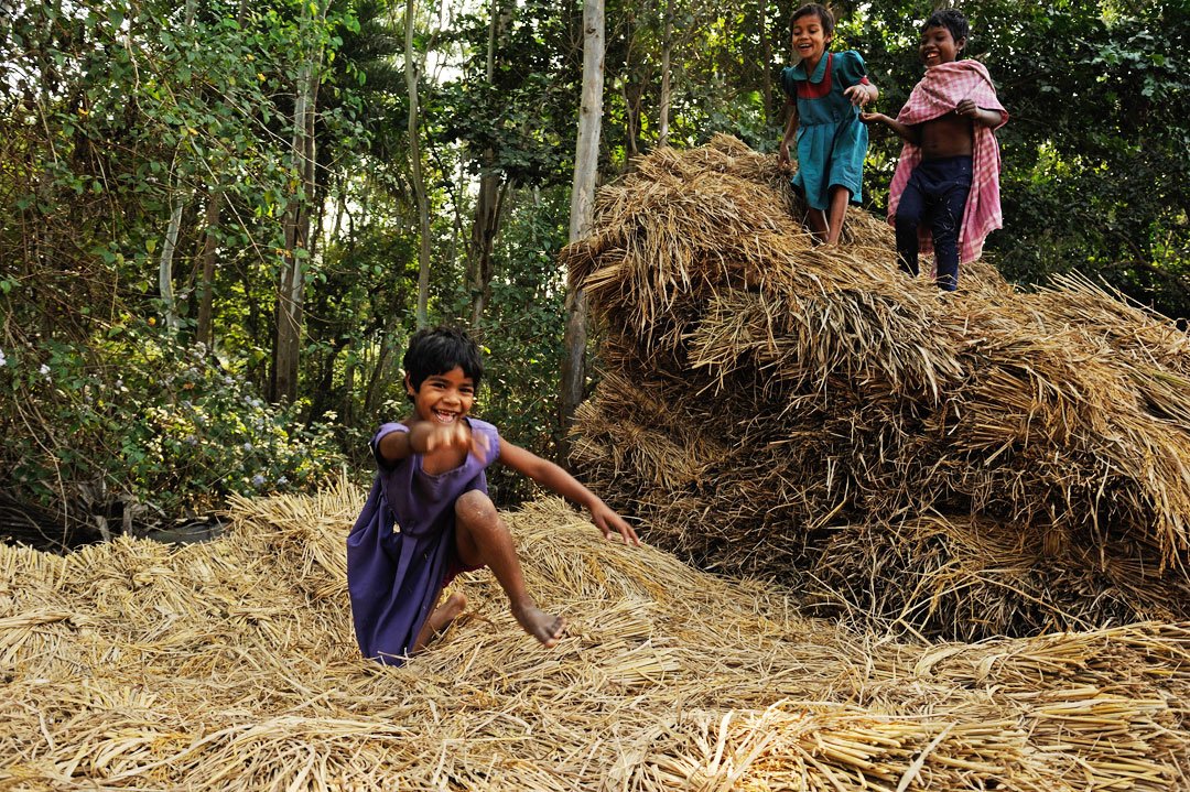 The kids invent their own games – a favourite is diving on a stack of dry straw from high up – in a school space that gives them the freedom to grow