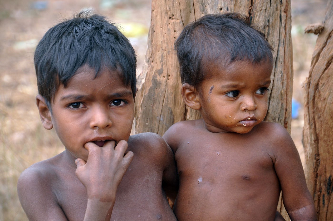 A boy looking after his younger brother.