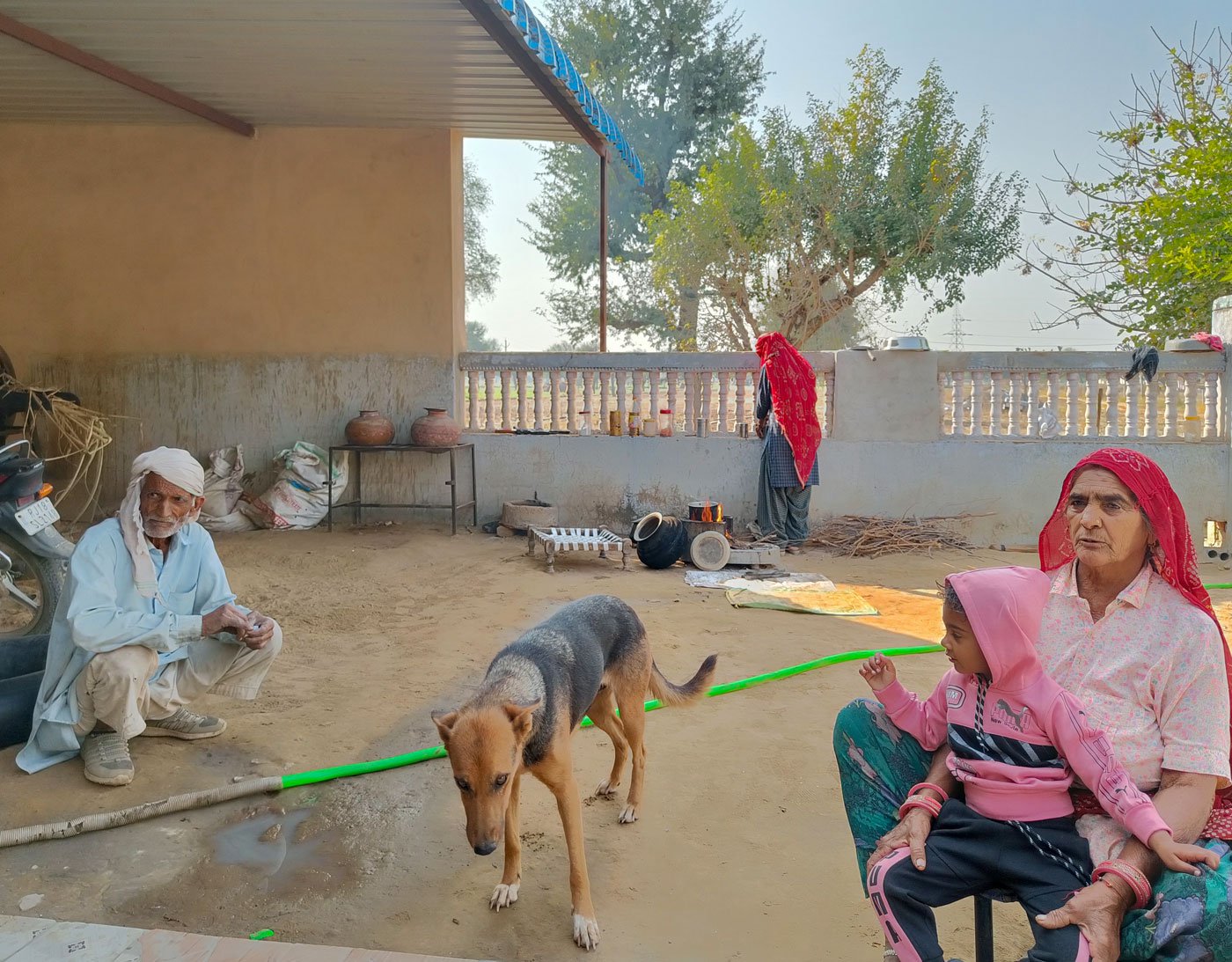 From left: Ruma’s father-in-law, Ruma near the wall, and her mother-in-law Yashoda with her grand-daughter on her lap. The family has adopted a dog who follows Yashoda's c ommands