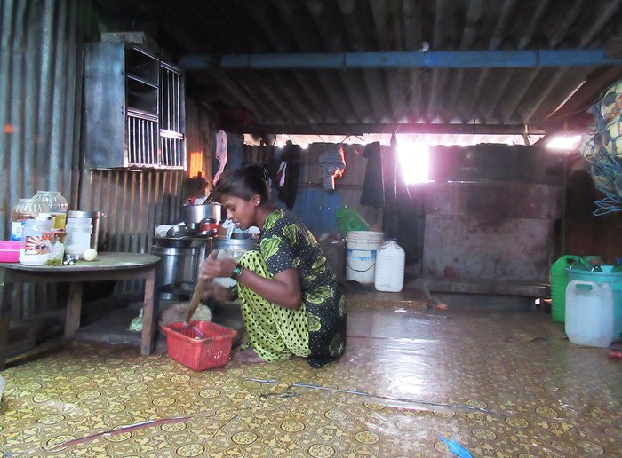 A woman crouching on the floor of her house