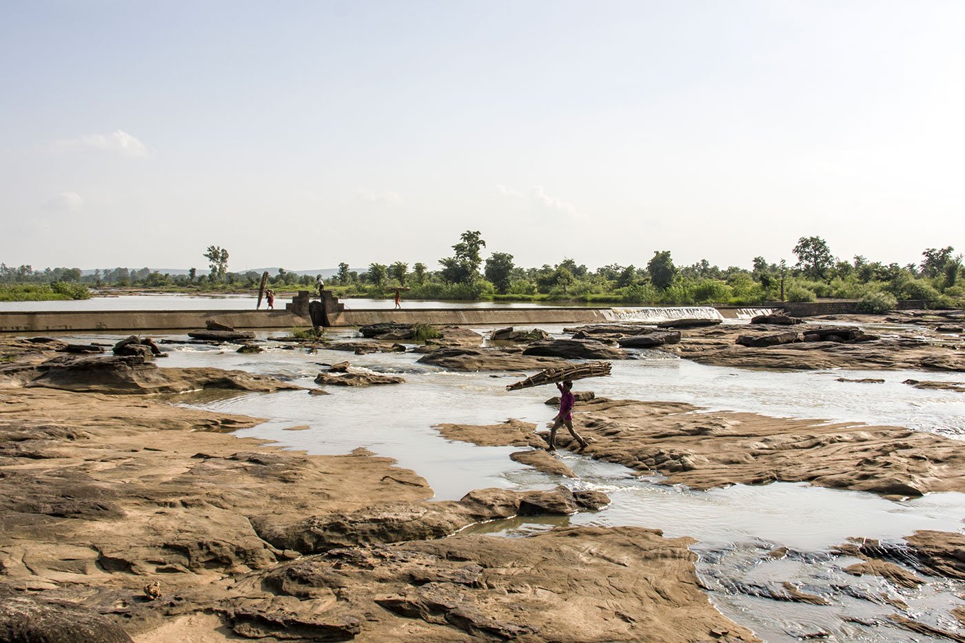 Crossing a tributary of the Mandakini river after collecting wood from the nearby forest